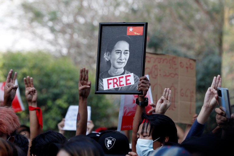 Demonstrators hold a portrait of detained State Counselor Aung San Suu Kyi