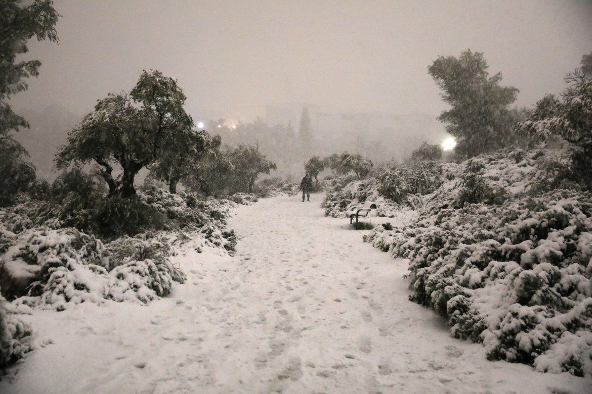 A person walks in the snow after a snowstorm at the Valley of the Cross in Jerusalem, 27 January 2022.