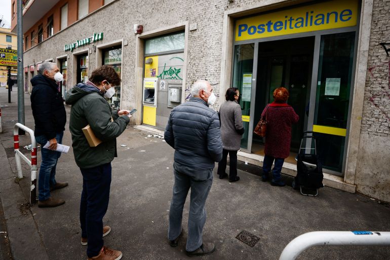 People wait in line outside a post office a day before COVID 'Green Pass' (health pass) becomes obligatory to access post offices, banks and many other stores and shops in Rome, Italy