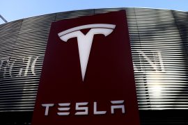 A logo of the electric vehicle maker Tesla is seen near a shopping complex in Beijing, China