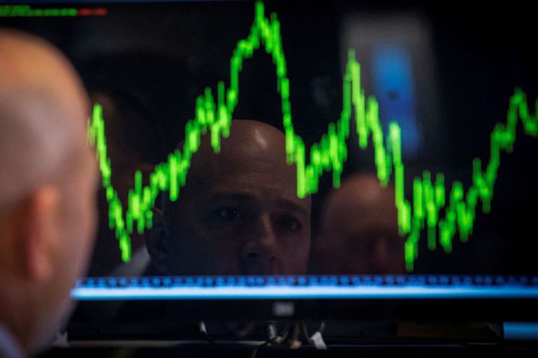 A trader watches his chart while working on the floor of the New York Stock Exchange