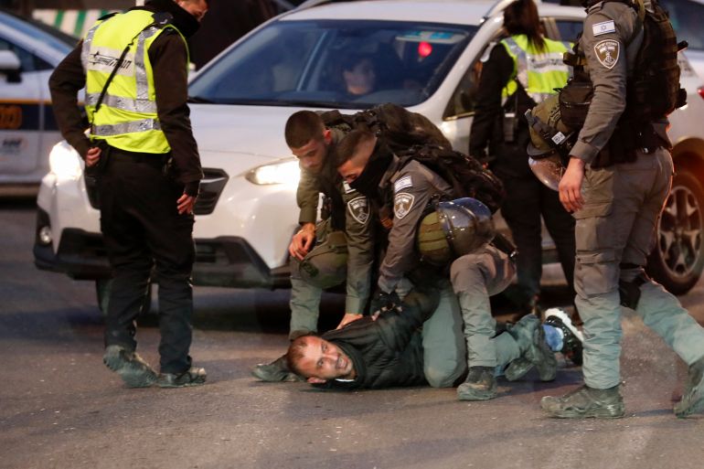 Israeli security forces arrest a Palestinian man in Sheikh Jarrah, occupied East Jerusalem