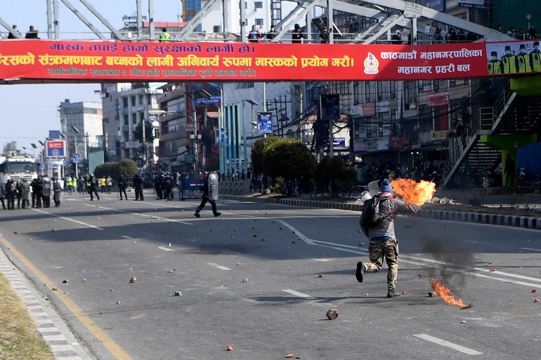 Demonstrators clash with police during a protest in Nepal