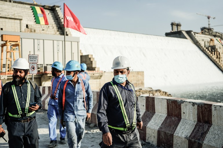Workers are seen walking at the site of the Grand Ethiopian Renaissance Dam (GERD) in Guba