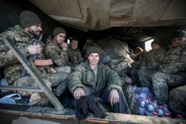 Ukraine's Military Forces servicemen sit in the back of military truck in the Donetsk region town of Avdiivka, on the eastern Ukraine front-line with Russia-backed separatists on February 21, 2022. - The rebel leaders of east Ukraine's two self-proclaimed republics asked Russian President to recognise the independence of their breakaway territories in a coordinated appeal on February 21. (Photo by Aleksey Filippov / AFP)