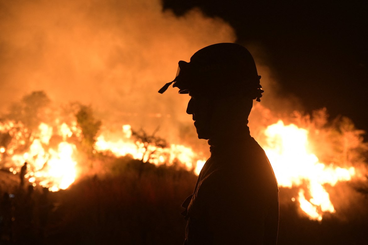 A firefighter controls the wildfires of native forest at Paraje Uguay,