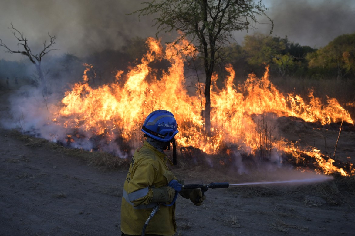Firefighter control the burned field