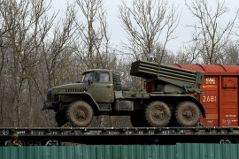 Russian military vehicles are seen loaded on train platforms some 50 km off the border with the self-proclaimed Donetsk People's Republic