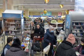 People queue to cash desks at a supermarket in Kharkiv