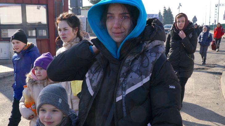 Ukrainian women and children cross the border from Ukraine to Poland