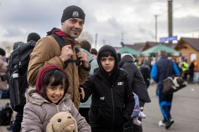 Ajmal Rahmani from Afghanistan and his children are seen at the Medyka pedestrian border crossing fleeing the conflict in Ukraine