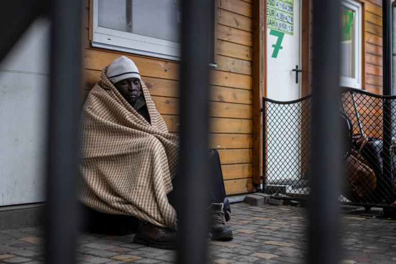 An African man rests as refugees from many countries - Africa, the Middle East and India - mostly students of Ukrainian universities are at the Medyka pedestrian border crossing fleeing the conflict in Ukraine, in eastern Poland