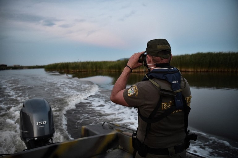A police officer patrols the delta of Evros River on a boat, near Alexandroupoli, Greece