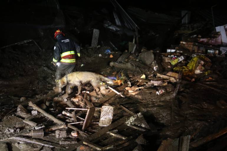 Picture released by Ecuadorean agency API showing people removing debris during the search of victims after a landslide caused by heavy rains in Quito
