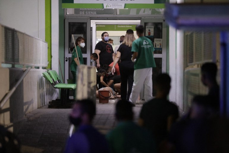 Relatives of people hospitalized after consuming cocaine cut with a toxic substance are seeen at San Bernardino Hospital in Hurlingham, Buenos Aires