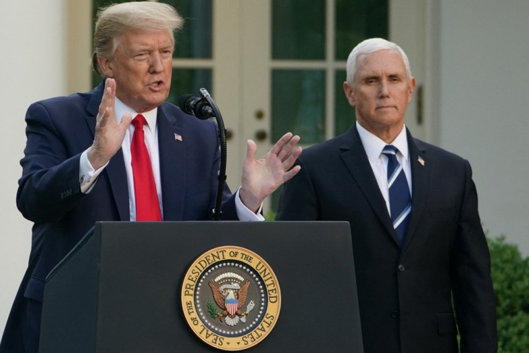 Former US President Donald Trump speaks as former US Vice President Mike Pence looks on during a news conference in the Rose Garden of the White House in Washington, DC