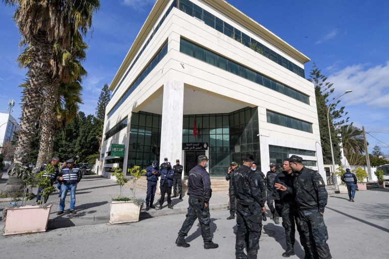 Members of the Tunisian security forces stand outside the closed headquarters of Tunisia's Supreme Judicial Council.
