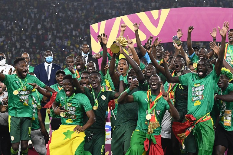 Senegal's players celebrate with the trophy after winning the Africa Cup of Nations 2021 final at Stade d'Olembe in Yaounde.