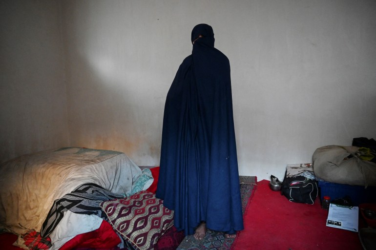 Azyta, who sold her kidney to raise money for her family, poses for a picture inside her house in Herat [Rouba El Husseini/AFP]