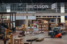 The Ericsson logo is seen as workers set up an exhibition stand for the company at the Mobile World Congress in Barcelona.