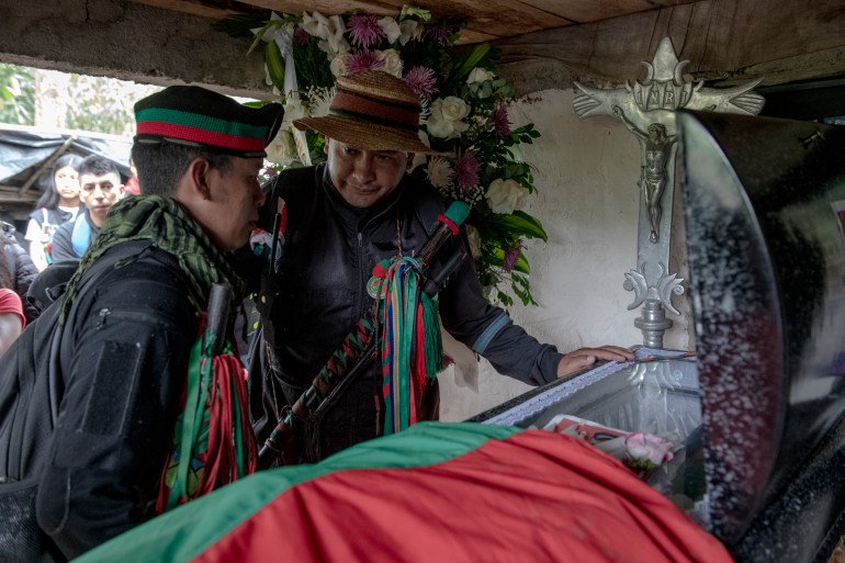 Two leaders of the Indigenous Guard come to pay their respects over the coffin of José Albeiro Camayo