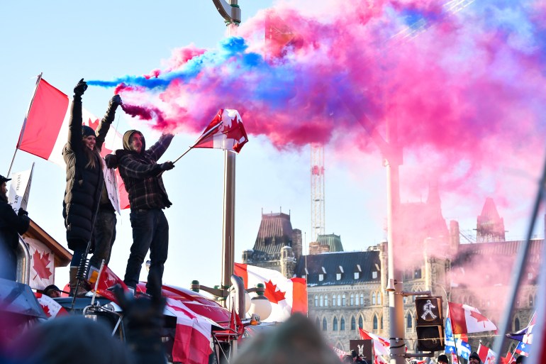 Protesters release smoke flares in front of Parliament in Ottawa, Canada.