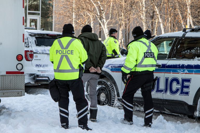 Police officers arrest a man in Ottawa