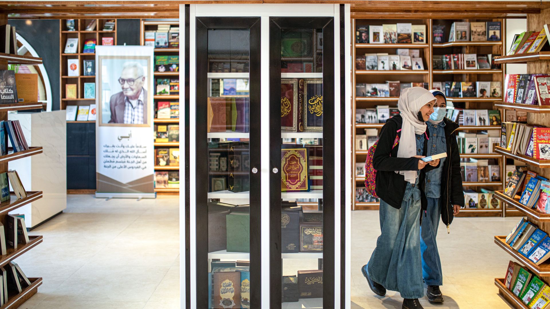 Girls browse for books in a bookstore