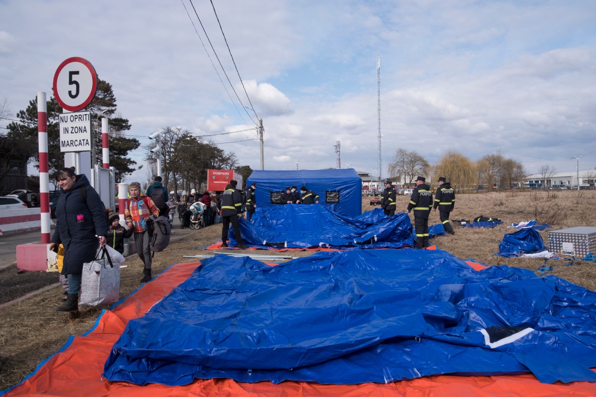 Romanian firefighters are building tents at the Siret border crossing to provide temporary shelter for the refugees waiting for transportation to other parts of the country.