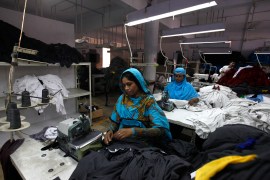 Women workers sew fabrics at a garment factory in Karachi, Pakistan