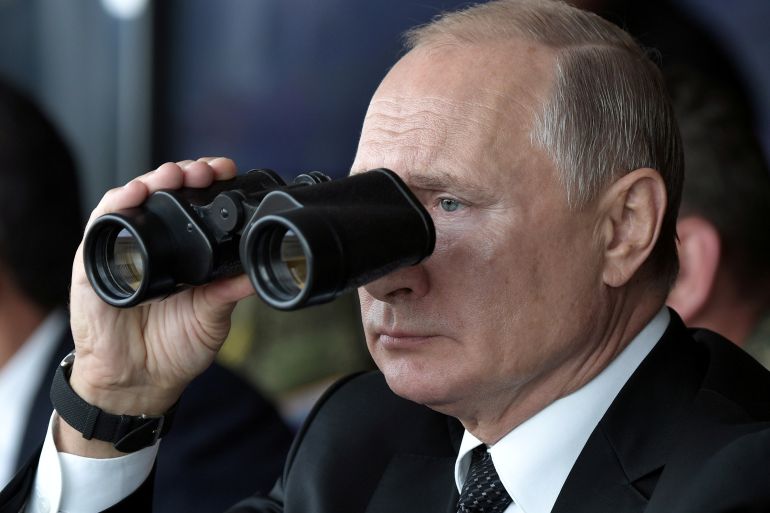 Russia's President Vladimir Putin uses a pair of binoculars while overseeing the military exercises known as "Centre-2019" at the firing range Donguz in Orenburg Region, Russia September 20, 2019.