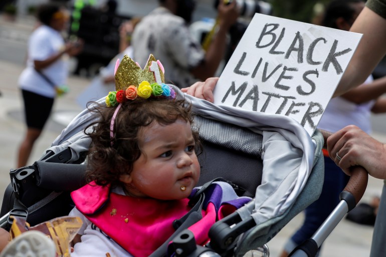 Baby in stroller with Black Lives Matter sign