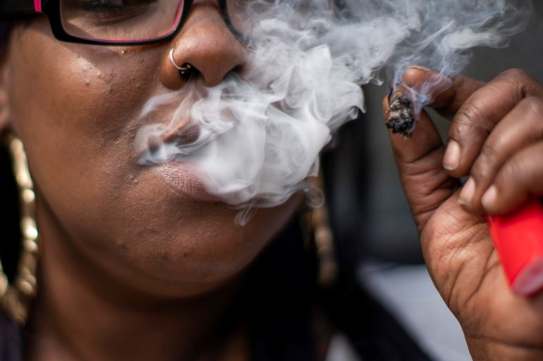 A woman smokes cannabis
