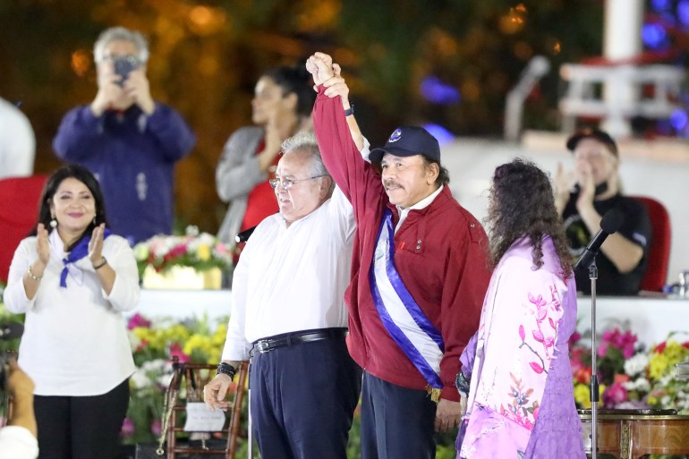 President of Nicaragua's National Assembly Gustavo Porras and Nicaragua's President Daniel Ortega hold hands next to Vice President Rosario Murillo, during the inauguration of Ortega's fourth consecutive term in office, in Managua, Nicaragua.