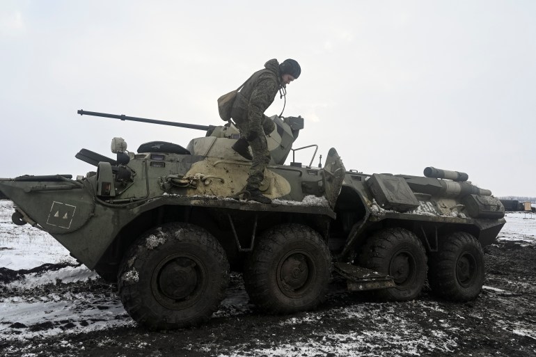 A Russian army service member is seen dismounting an armoured personnel carrier during drills at the Kuzminsky range in the southern Rostov region, Russia