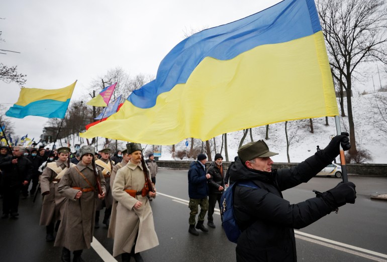 People holding flags take part in a march in Kyiv, Ukraine