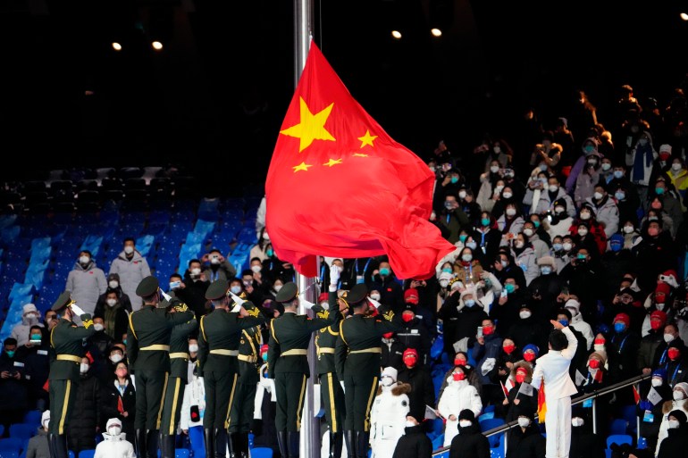 The flag of China is brought into the stadium and raised during the Opening Ceremony of the Beijing 2022 Winter Olympic Games at Beijing National Stadium.