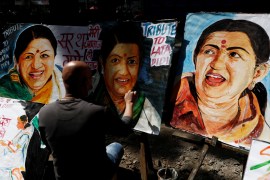 An artist paints a tribute to late Indian singer and music composer Lata Mangeshkar after she passed away, in Mumbai, India