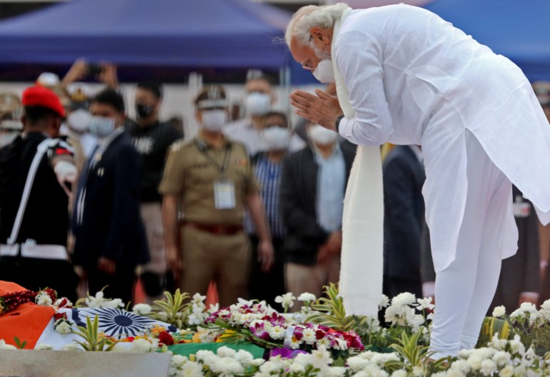 India's Prime Minister Narendra Modi pays his respects to late Indian singer Lata Mangeshkar during her funeral at Shivaji Park in Mumba