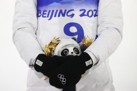 Gold medalist Peter Prevc of Slovenia holds an award depicting Bing Dwen Dwen, one of the mascots of the Beijing 2022 Winter Olympics on the podium.