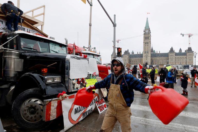 A demonstrator screams and bangs gas canisters together as truckers and supporters continue to protest coronavirus disease (COVID-19) vaccine mandates, in Ottawa., Canada