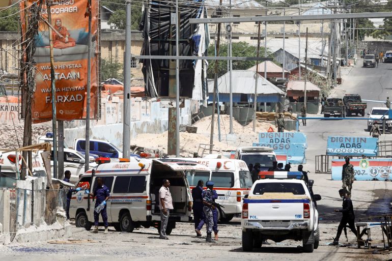 Somali security forces secure the road leading to the scene of an explosion at a checkpoint near the presidential palace in Mogadishu, Somalia