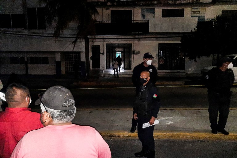 Police officers guard the perimeter of a scene where Heber Lopez, an independent journalist who ran NoticiasWeb, was shot dead at his recording studio