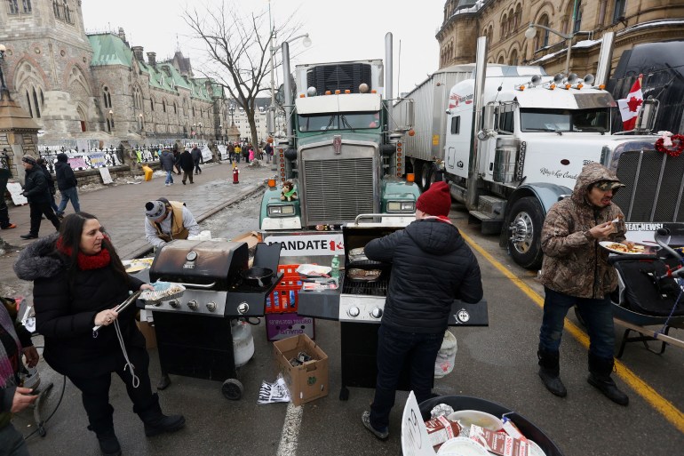 Protesters prepare food in front of Parliament Hill and parked trucks, as truckers and supporters continue to protest coronavirus disease (COVID-19) vaccine mandates, in Ottawa, Ontario, Canada, 