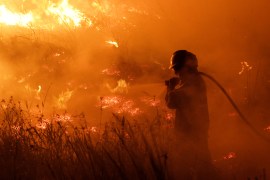 A firefighter battles a wildfire that has spread over more than 500,000 hectares in the norther province of Corrientes, in Portal San Antonio, Argentina February 14, 2022. Picture taken February 14, 2022. REUTERS/Sebastian Toba