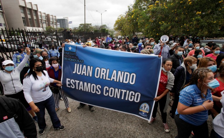 Supporters of Honduras former President Juan Orlando Hernandez carrying banner