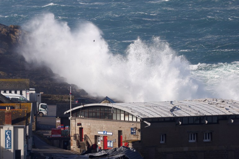 Waves crash over the lifeboat station in Cornwall