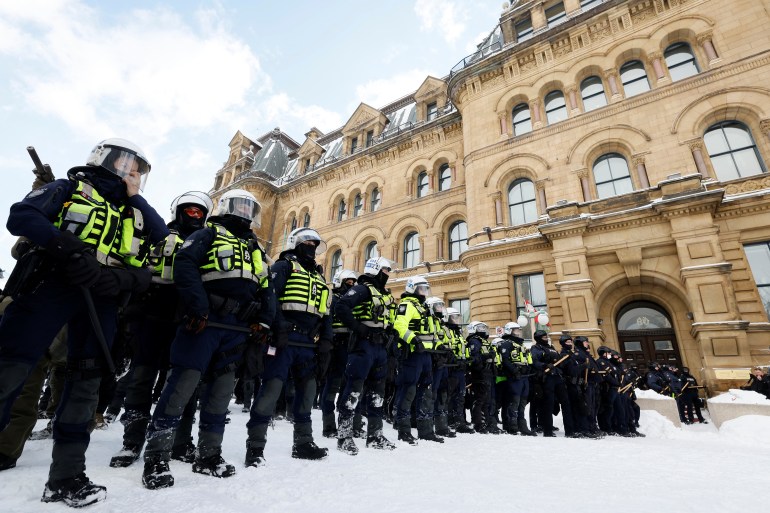 Canadian police stand in a line in downtown Ottawa