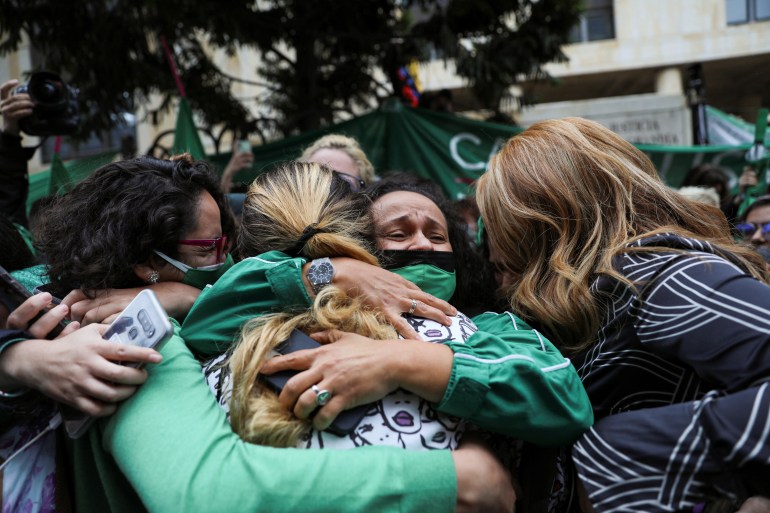 a group of women hug each other outside Colombia's constitutional court in Bogota