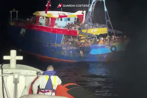 Italy's COASTGUARD PATROL BOAT APPROACHING migrant BOAT IN DISTRESS